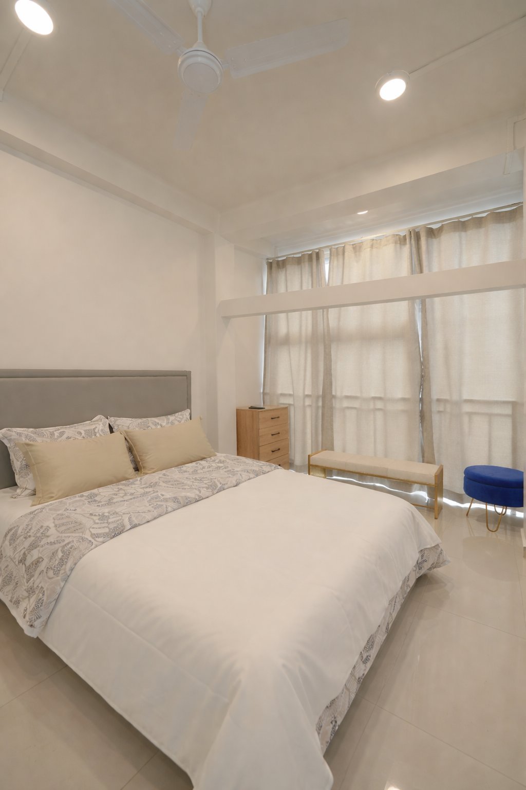 Deluxe Room — spacious bed with wardrobe